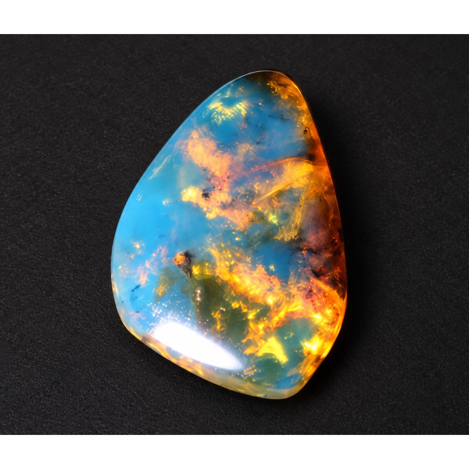 Nature created orange blue Dominican amber cabochon